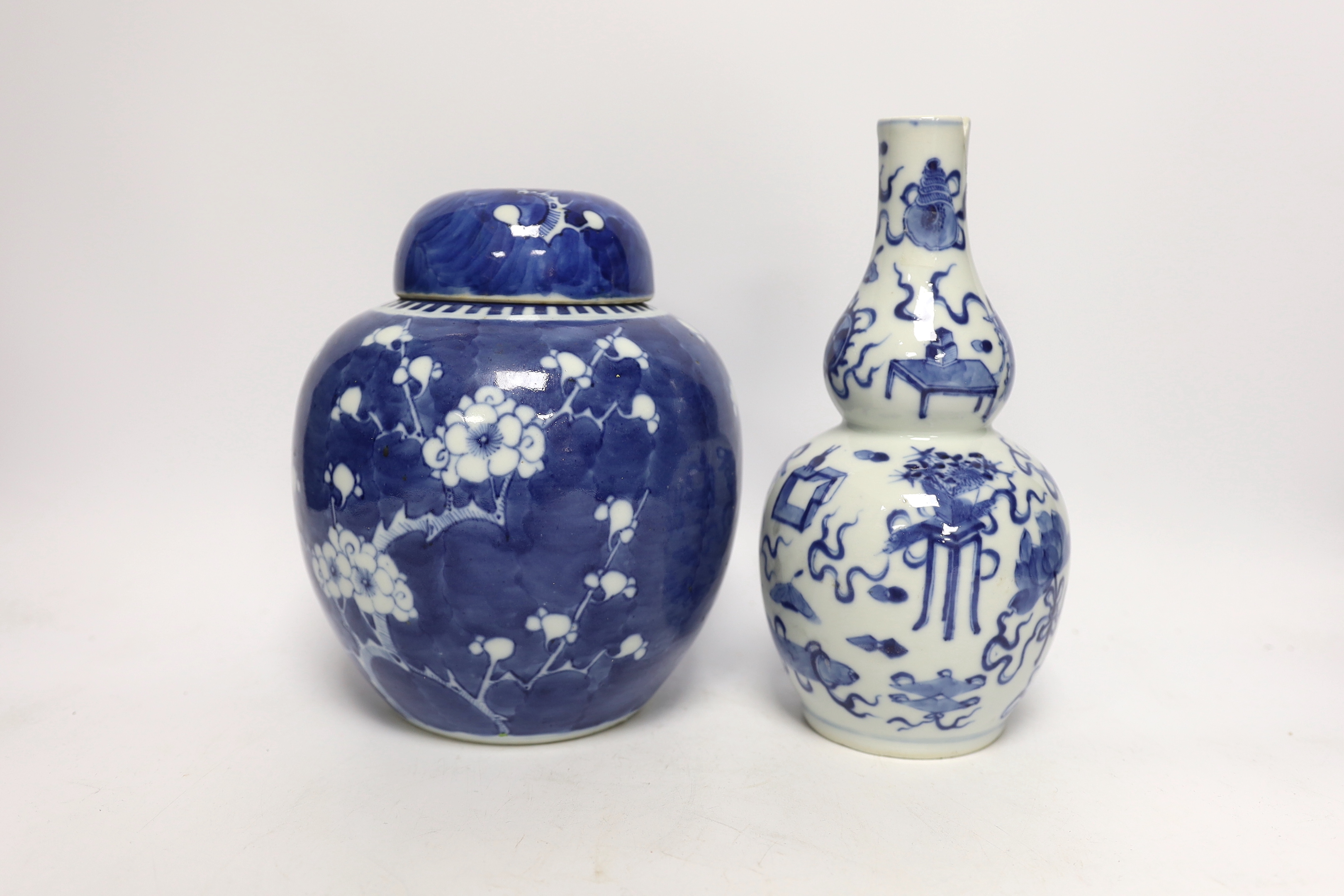 A Chinese blue and white prunus jar and cover and a double gourd vase, late 19th/early20th century, tallest 23cm